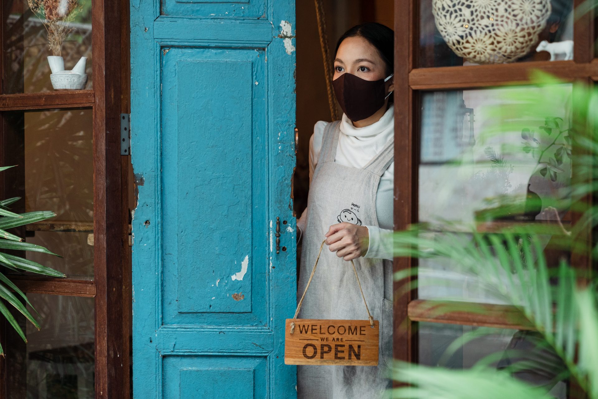 woman at shop front in mask