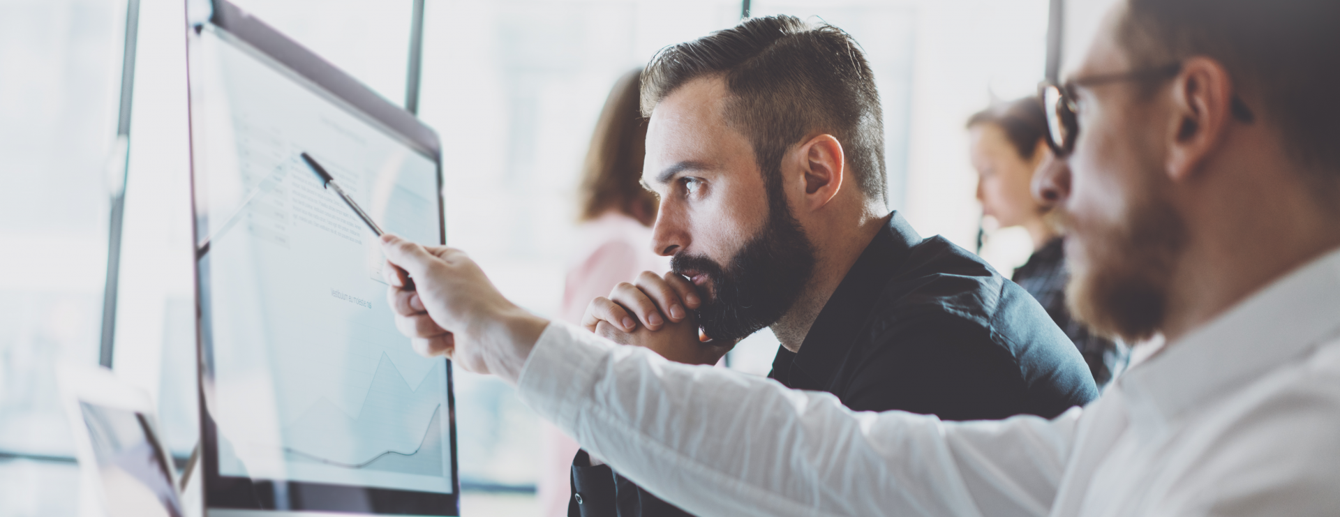 data analyst discussing work with colleague - business intelligence reporting concept